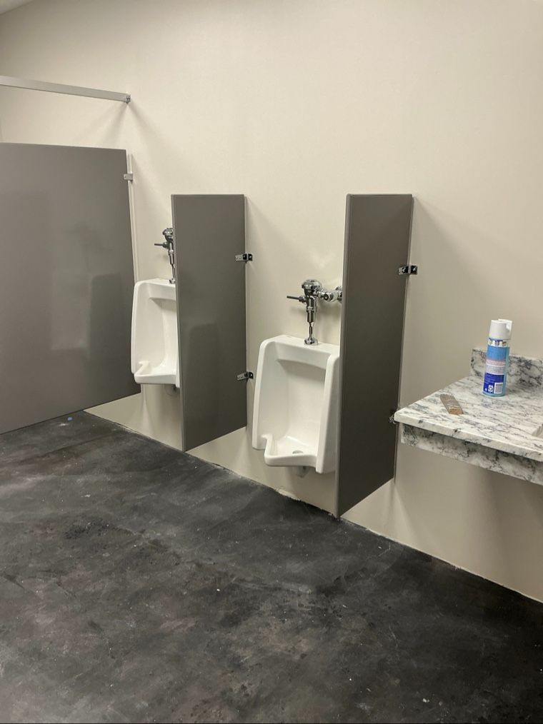 Urinal privacy screens and bathroom partitions with stainless steel floor-to-ceiling hardware
