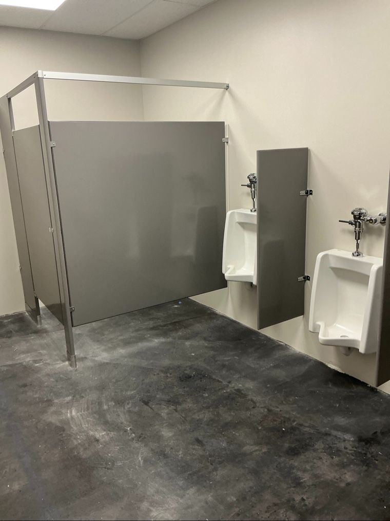 Commercial bathroom partitions with urinal privacy screens and toilet stalls