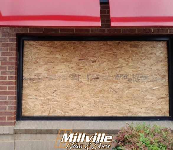Commercial window boarded after glass breakage