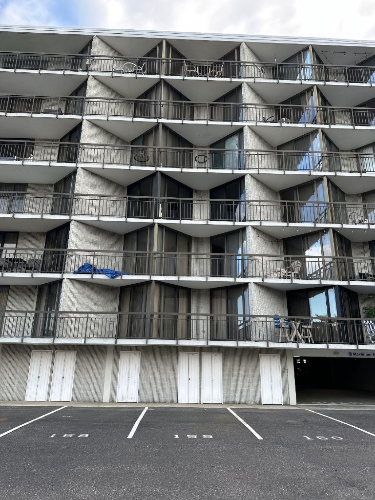 Ocean Colony condominium building exterior — multi-story sliding glass door replacement project