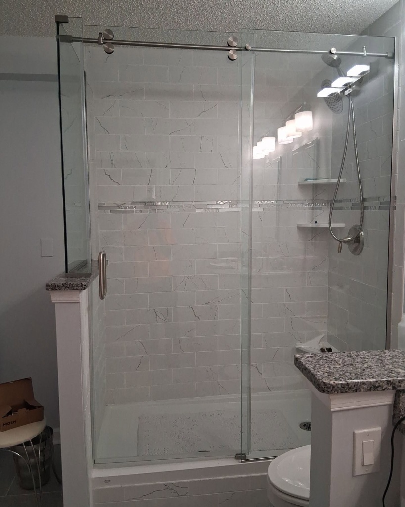 Custom residential shower glass enclosure installed by Millville Glass and Door